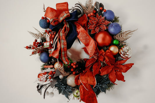 Nutcracker Christmas wreath with vibrant red, blue, and green ornaments.

Handcrafted holiday wreath with poinsettias, berries, and luxury ribbon.

Festive front-door wreath featuring Nutcracker and plaid accents.

Red and blue Christmas wreath designed by Duvall Designs.

Elegant Nutcracker wreath with traditional holiday colors.

Vibrant Christmas door décor with ornaments and lush greenery.

Whimsical handcrafted wreath featuring Nutcracker and glitter poinsettias.

Traditiona red and blue holiday wreath