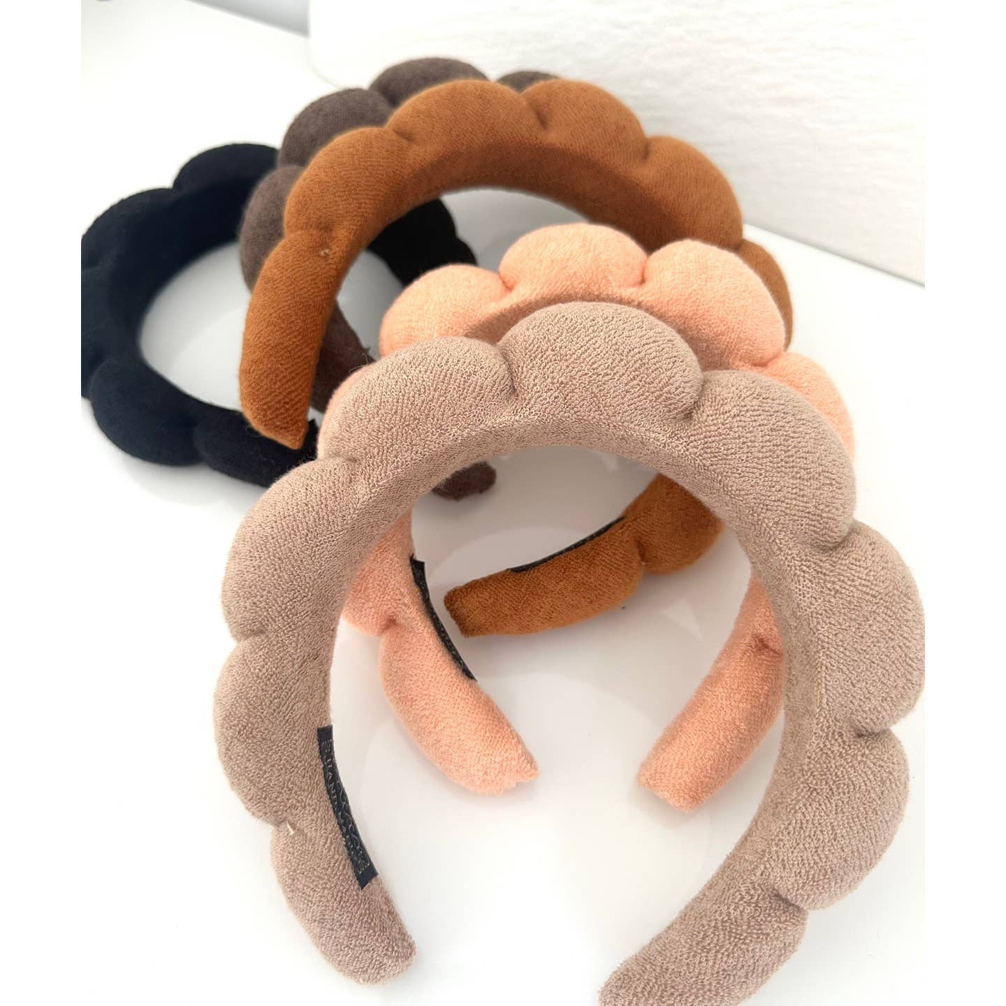 Cozy spa headband keeping hair secure during face washing and beauty treatments.