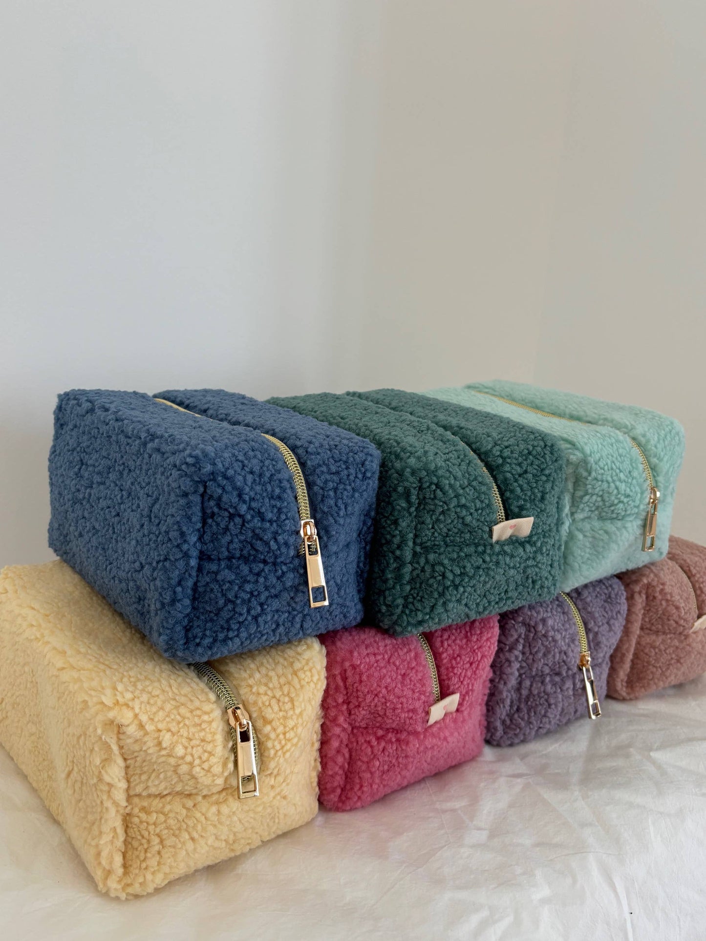 Boutique aesthetic makeup bag with cozy teddy bear texture and minimalist design.